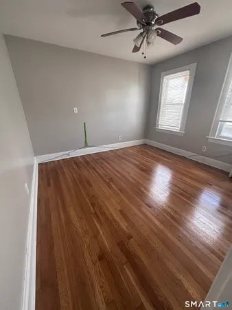 wooden floor in an empty room with a window