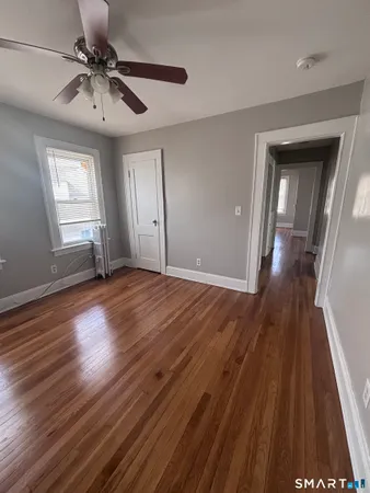 a view of a hallway with wooden floor