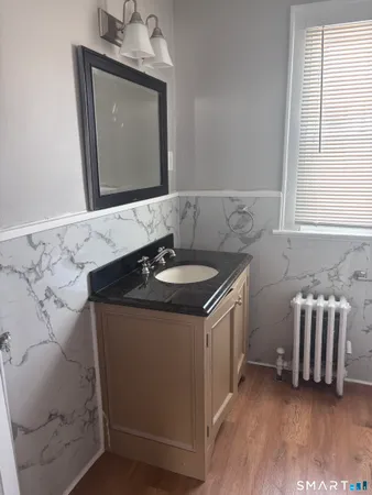 a bathroom with a sink a bathtub and a window