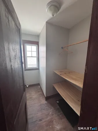 a bedroom with furniture and wooden floor