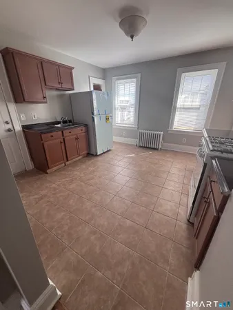 a large bedroom with a bed and a window