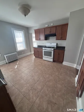 a kitchen with stainless steel appliances a refrigerator sink and cabinets
