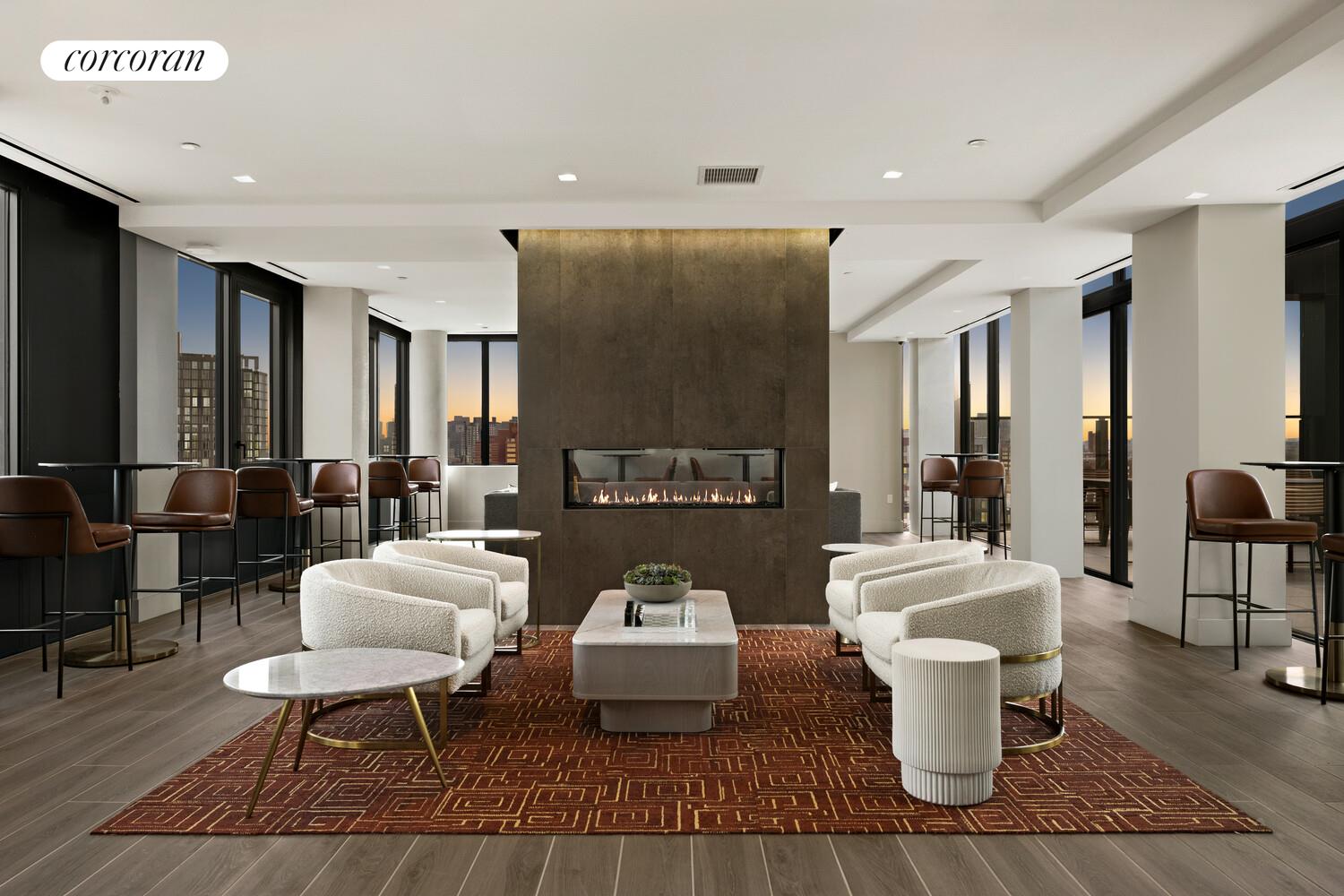 166-20 90th Avenue, Unit 433 Queens, NY 11432 - Photo 13 of 15 a living room with furniture a table and kitchen view