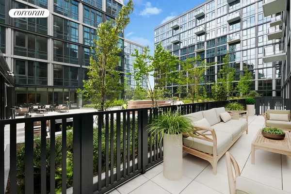 a view of a balcony with chairs and potted plants