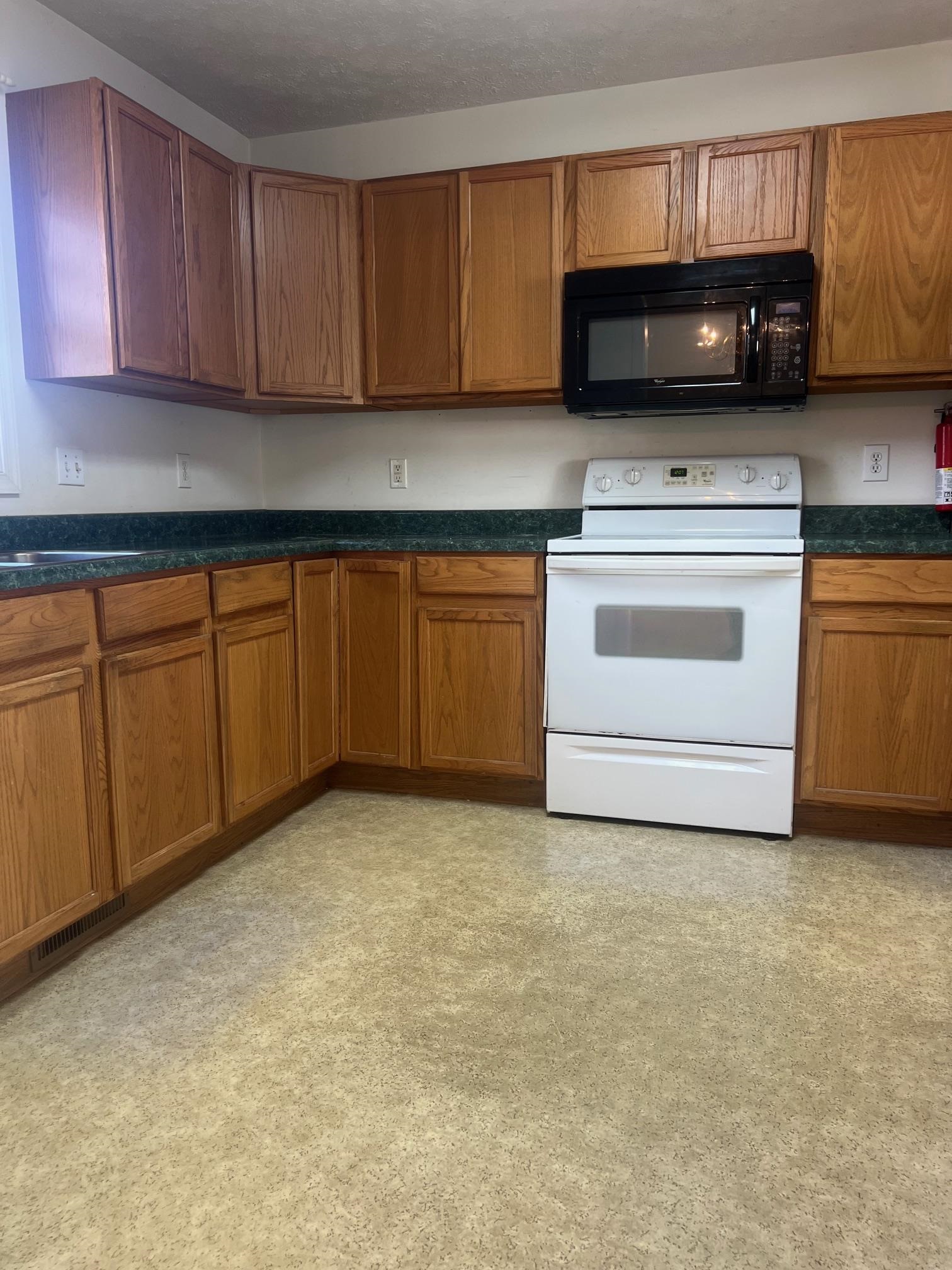 512 F Street Staunton, VA 24401 - Photo 13 of 27 a kitchen with stainless steel appliances granite countertop a stove a sink and a granite counter tops