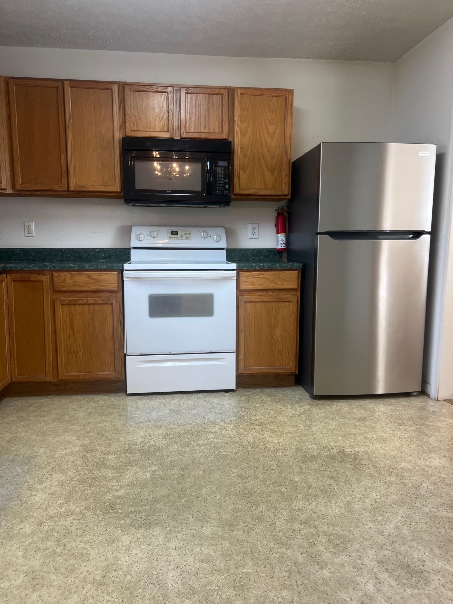 512 F Street Staunton, VA 24401 - Photo 14 of 27 a kitchen with granite countertop a stove a refrigerator and a sink