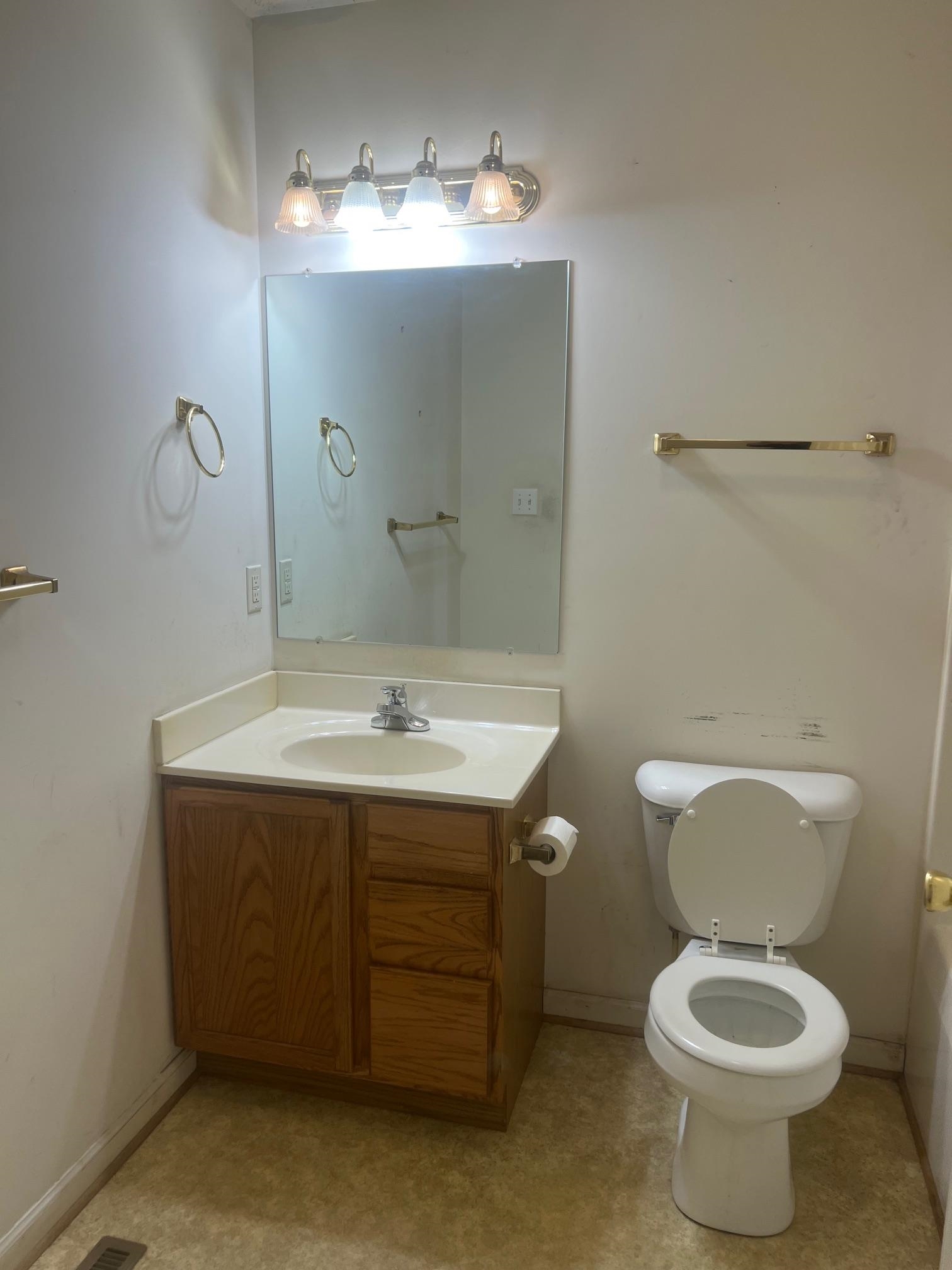 512 F Street Staunton, VA 24401 - Photo 16 of 27 a bathroom with a toilet sink and mirror
