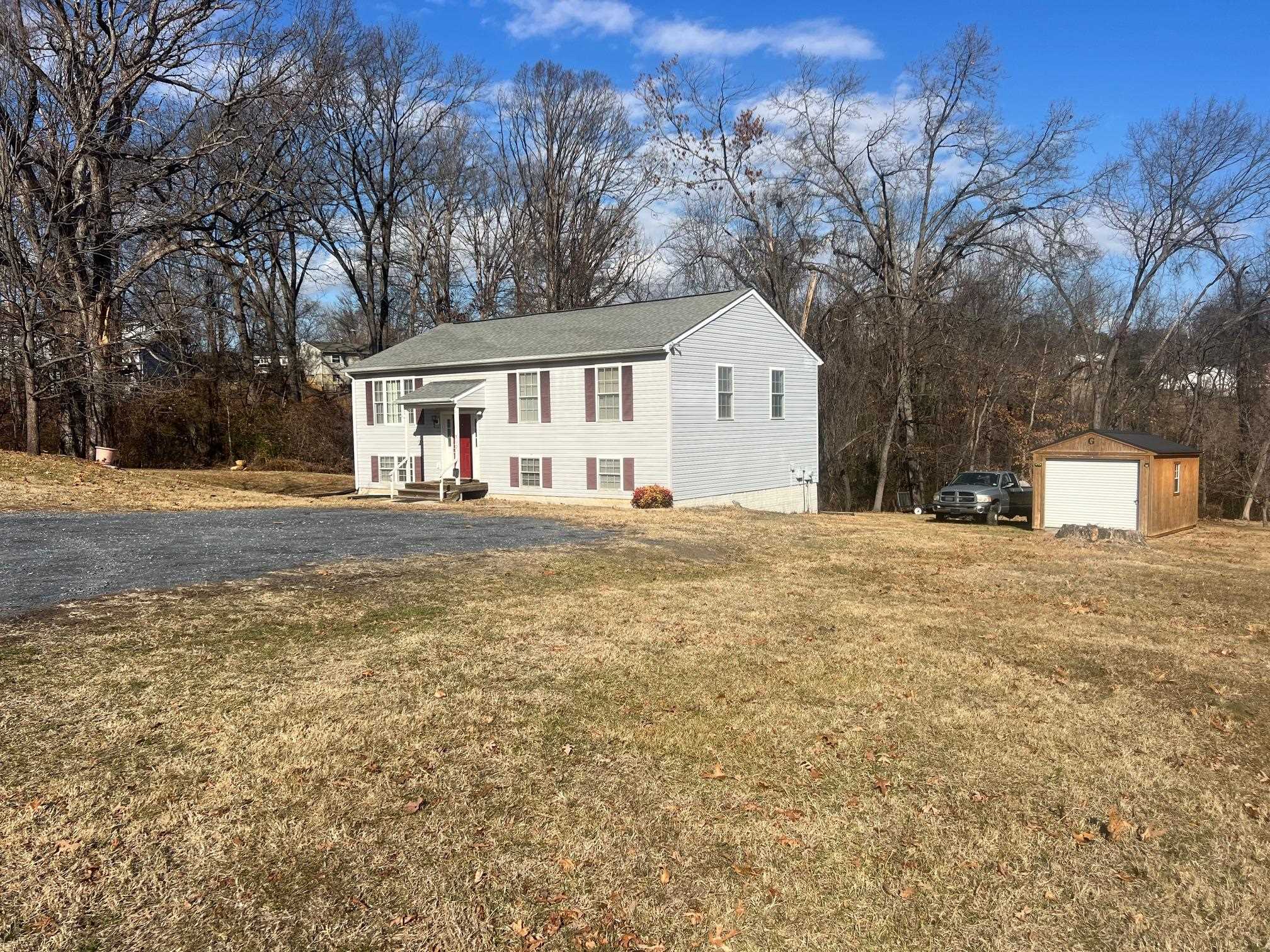 512 F Street Staunton, VA 24401 - Photo 9 of 27 a front view of a house with a yard and garage