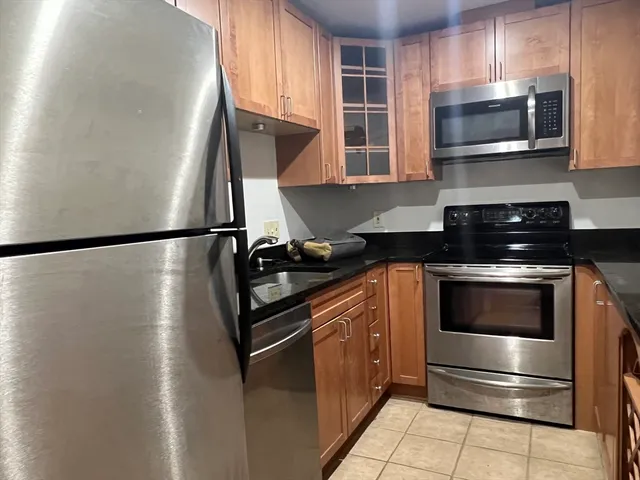 a kitchen with stainless steel appliances and cabinets