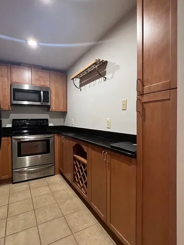 a kitchen with stainless steel appliances a refrigerator and a stove top oven