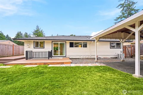 a view of backyard with a deck
