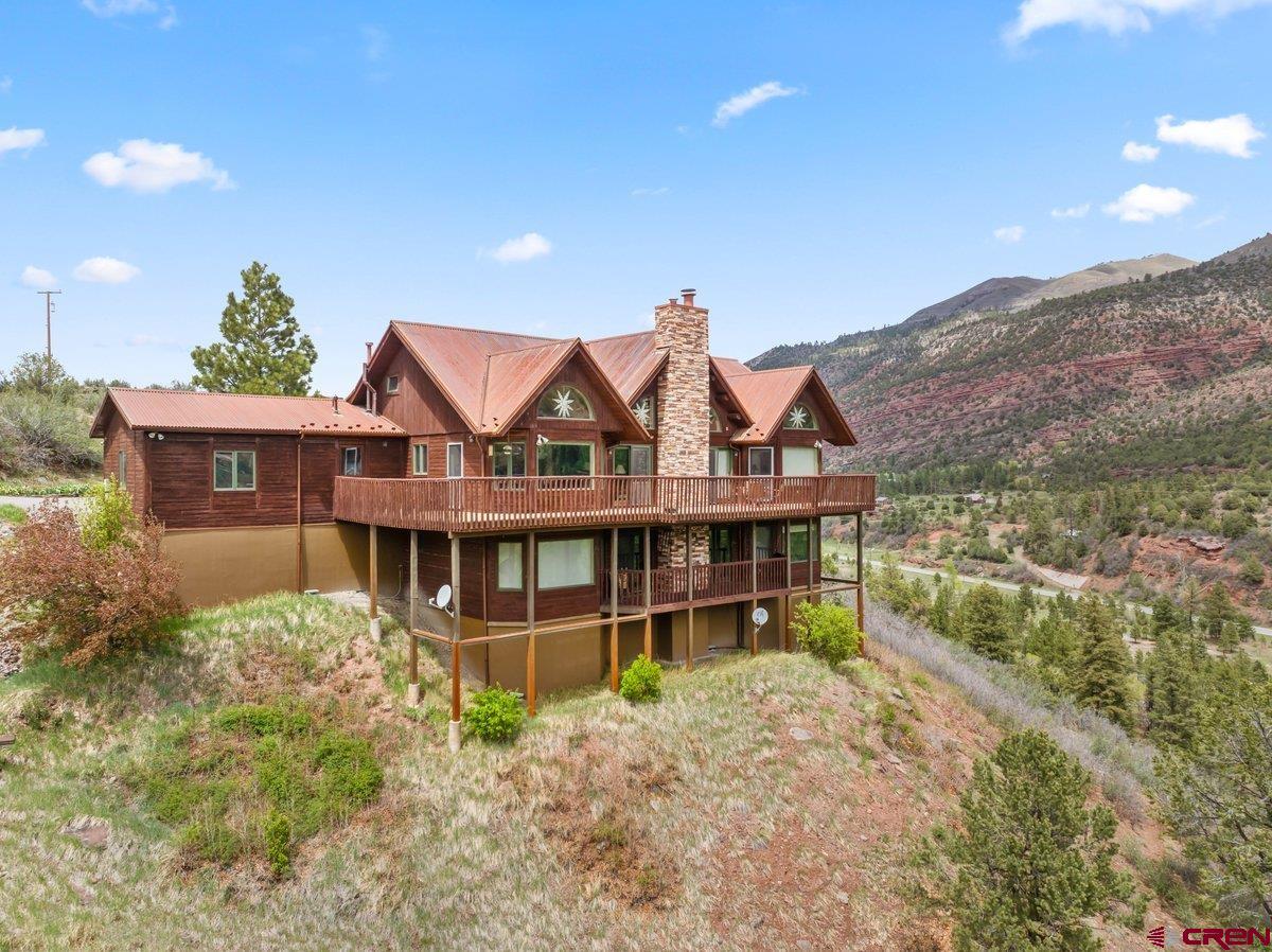 2490 County Road 17 Ridgway, CO 81432 - Photo 10 of 26 a view of a house with a yard and balcony
