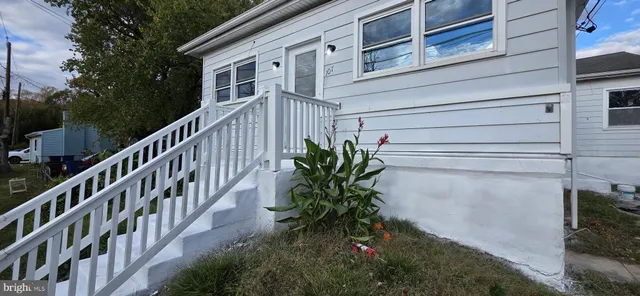 a view of a house with brick walls and flower plants