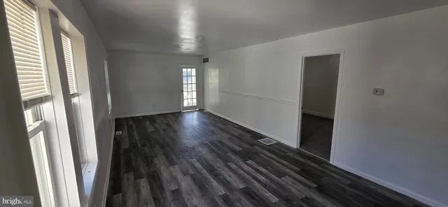 a view of a room with wooden floor and window
