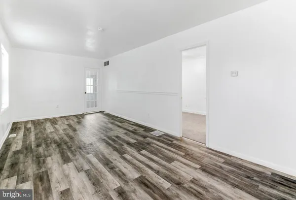 a view of a room with wooden floor