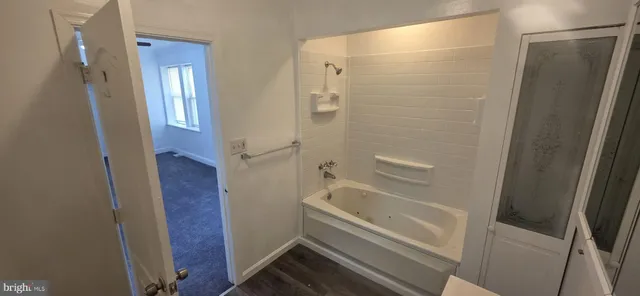 a bathroom with a sink and mirror with toilet