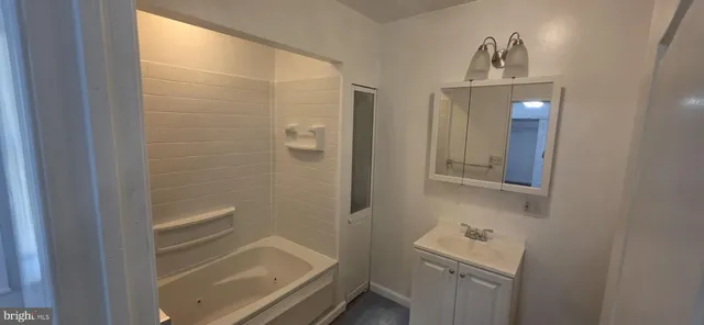 a kitchen with stainless steel appliances a refrigerator a sink a stove a microwave and wooden floors