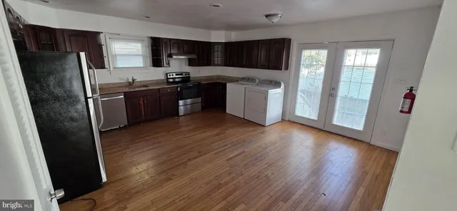 a kitchen with stainless steel appliances granite countertop a refrigerator and a stove top oven