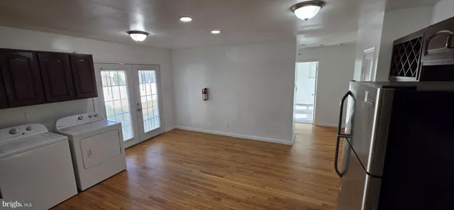 a kitchen with stainless steel appliances wooden cabinets and wooden floors