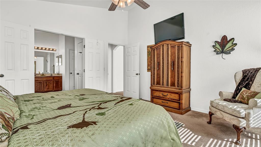 1153 Legatto Loop Dundee, FL 33838 - Photo 21 of 48 a bedroom with a bed and flat screen tv
