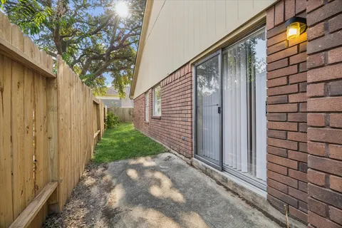 a view of a pathway of a house with backyard and tree