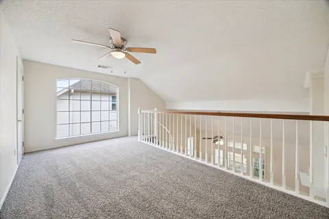 a view of empty room with ceiling fan