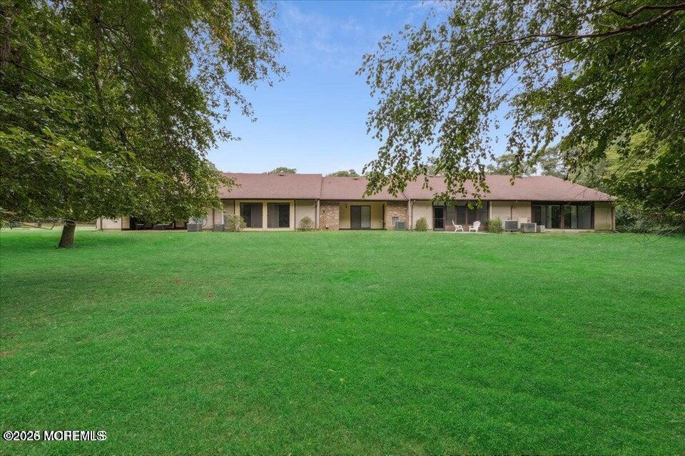 70 Overlook Way, Unit E Manalapan, NJ 07726 - Photo 19 of 20 a view of a house with a yard