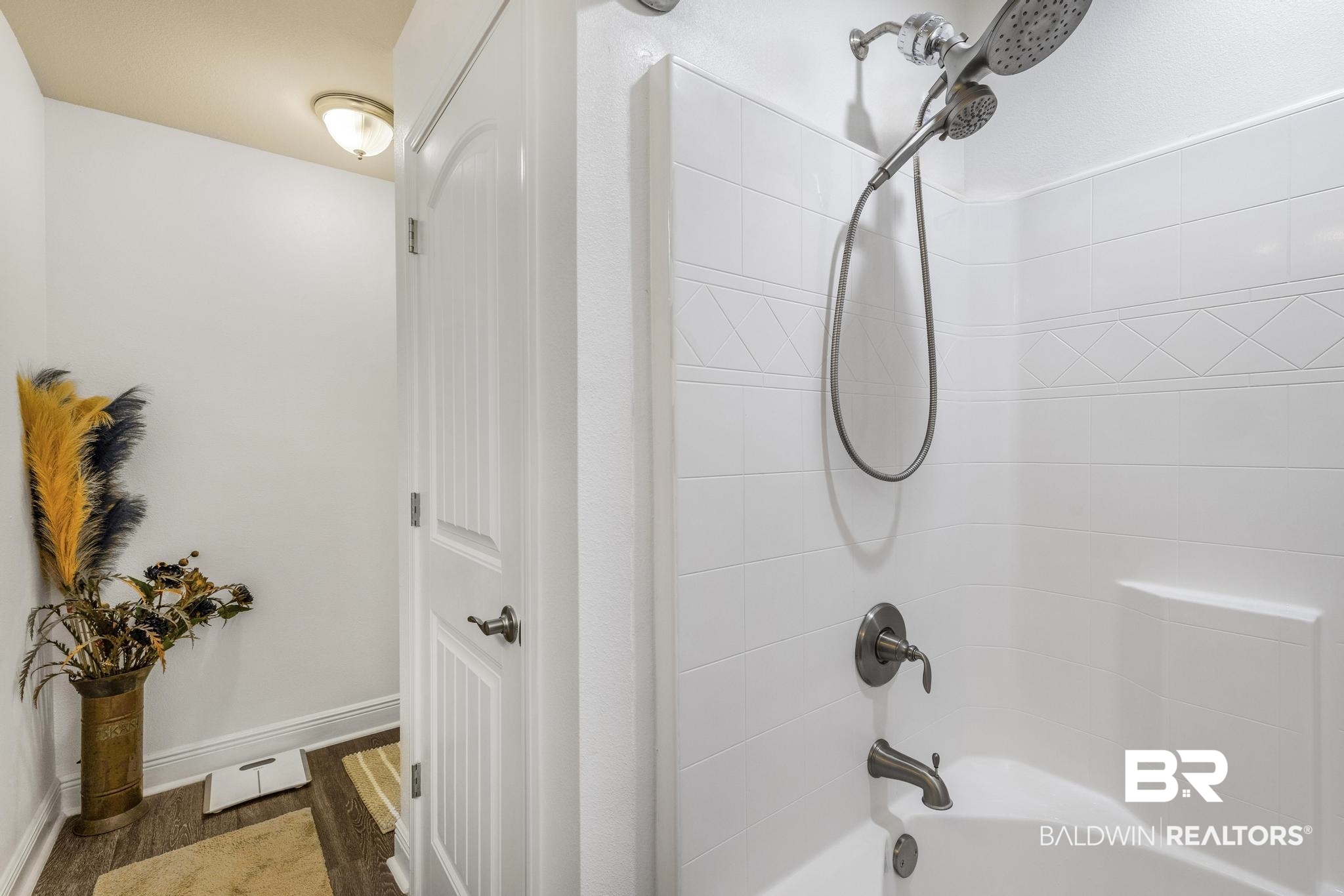22043 Garland Loop Silverhill, AL 36576 - Photo 24 of 41 Bathroom featuring shower combination and dark wood-style floors