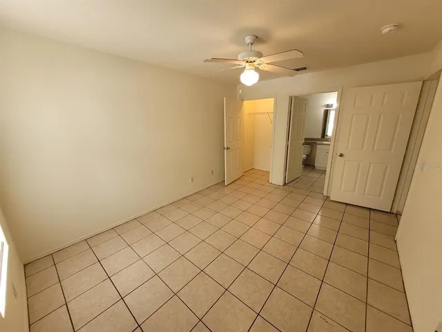 an empty room with kitchen view