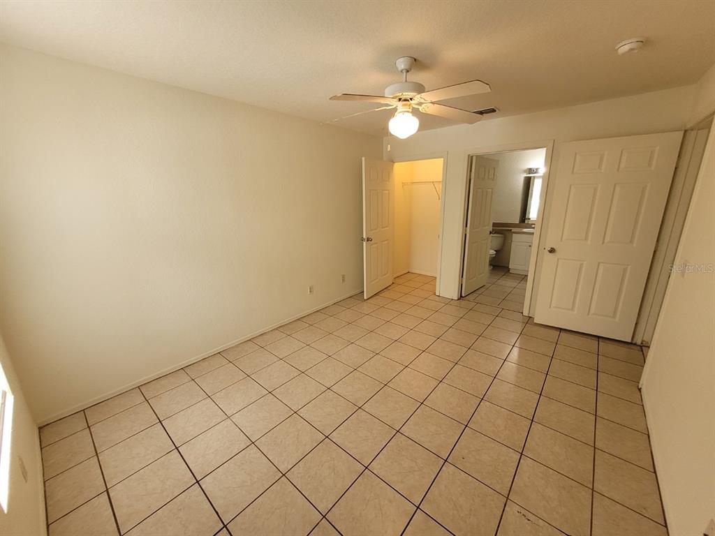 36037 Deer Creek Drive, Unit 102 Zephyrhills, FL 33541 - Photo 14 of 44 an empty room with kitchen view