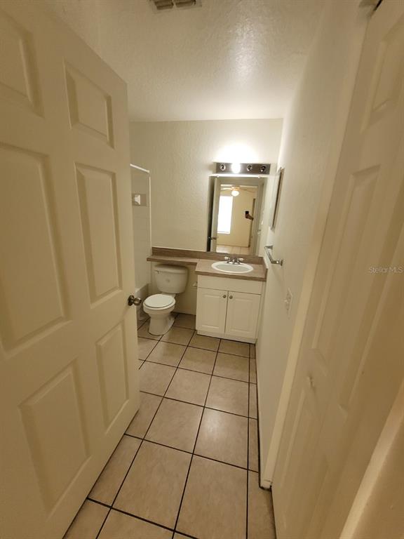 36037 Deer Creek Drive, Unit 102 Zephyrhills, FL 33541 - Photo 18 of 44 a bathroom with a sink toilet and shower