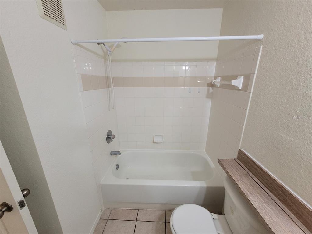 36037 Deer Creek Drive, Unit 102 Zephyrhills, FL 33541 - Photo 19 of 44 a bathroom with a tub and shower