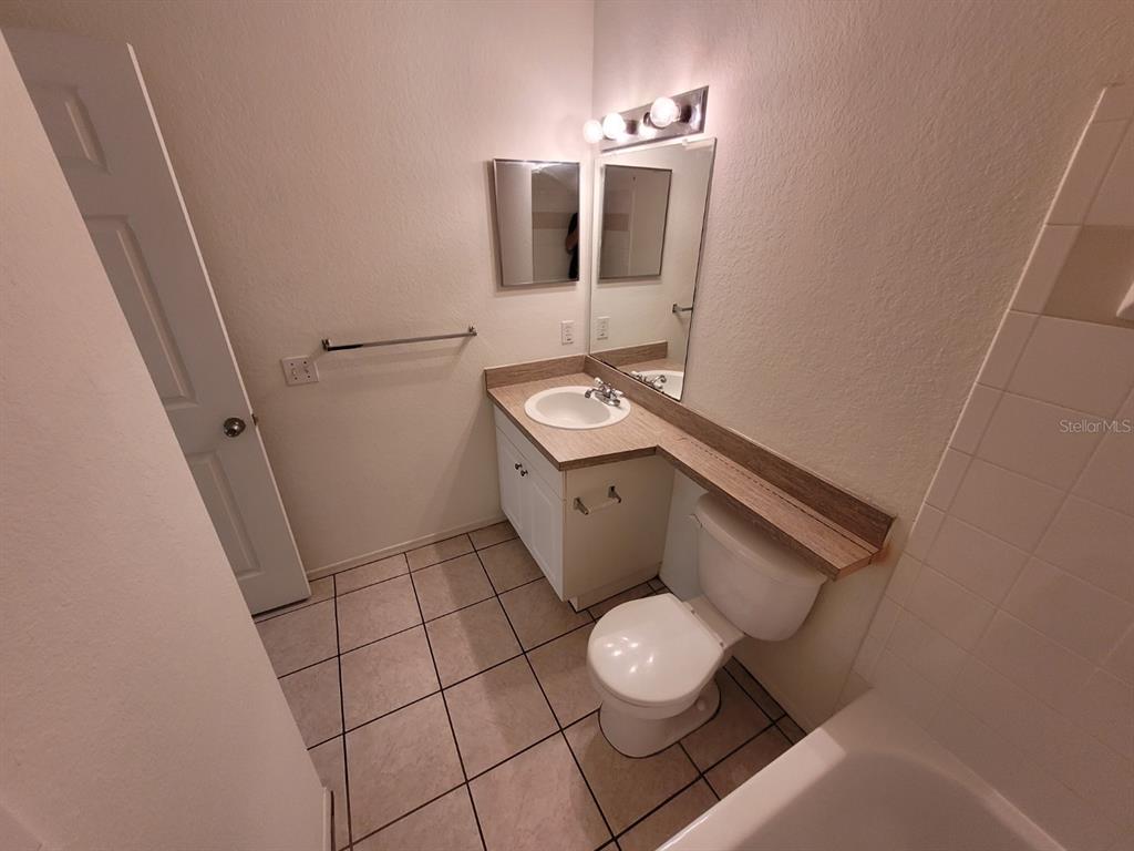 36037 Deer Creek Drive, Unit 102 Zephyrhills, FL 33541 - Photo 26 of 44 a bathroom with a toilet and a sink