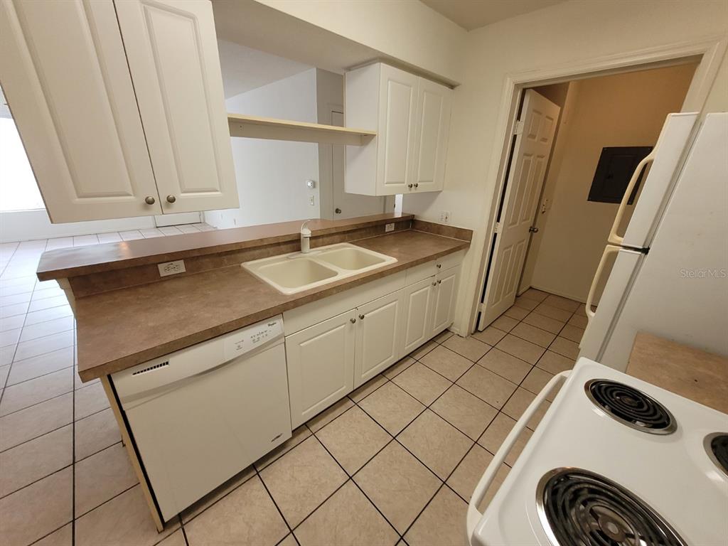 36037 Deer Creek Drive, Unit 102 Zephyrhills, FL 33541 - Photo 9 of 44 a sink a washer and dryer