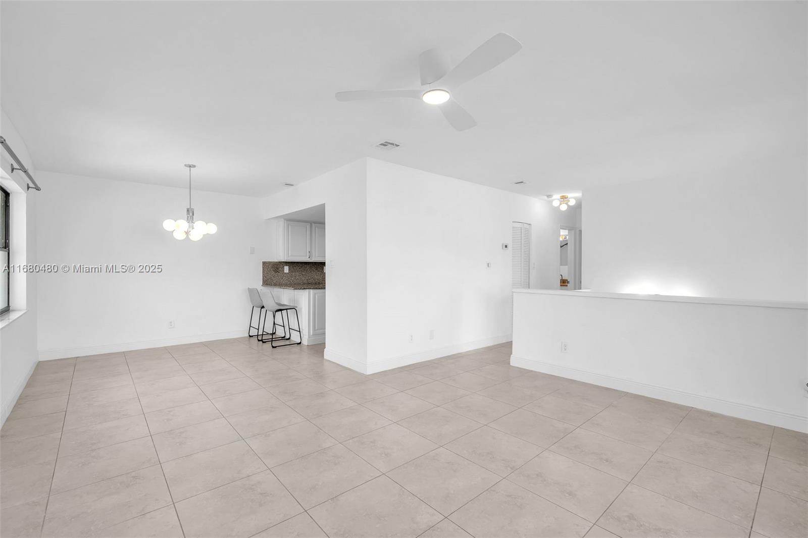 11533 Southwest 109th Road, Unit 21G Miami, FL 33176 - Photo 12 of 39 a view of an empty room with kitchen and a window