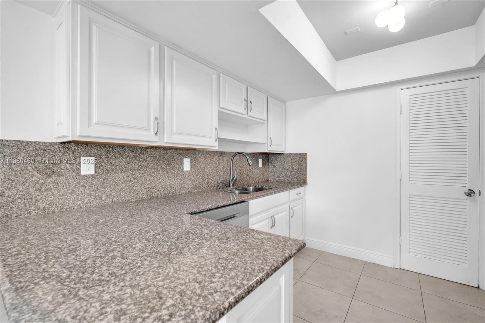 11533 Southwest 109th Road, Unit 21G Miami, FL 33176 - Photo 13 of 39 a kitchen with a sink and cabinets