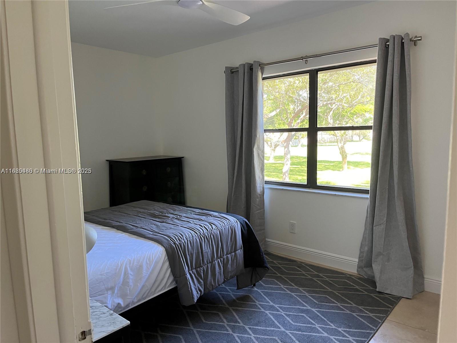 11533 Southwest 109th Road, Unit 21G Miami, FL 33176 - Photo 20 of 39 a bedroom with a bed and a window