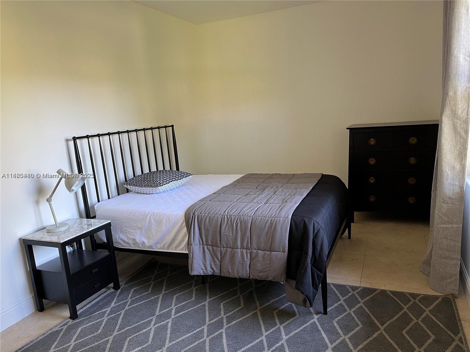11533 Southwest 109th Road, Unit 21G Miami, FL 33176 - Photo 21 of 39 a bedroom with a bed and a dresser