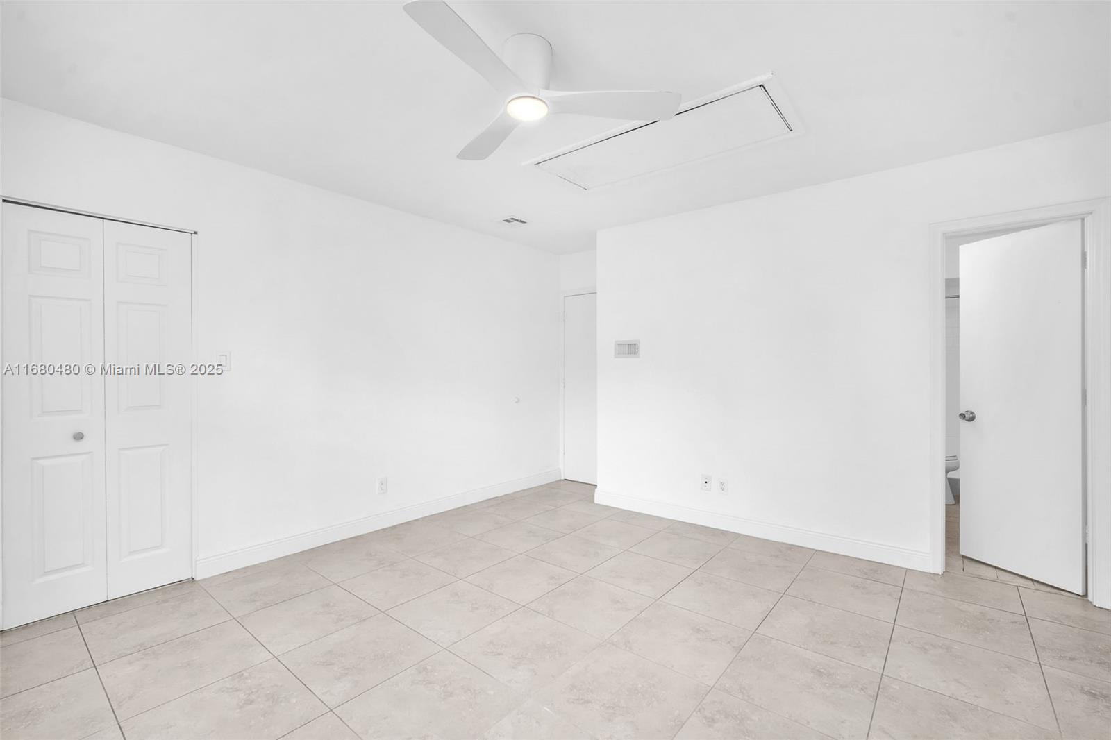 11533 Southwest 109th Road, Unit 21G Miami, FL 33176 - Photo 23 of 39 an empty room with white walls and tiles