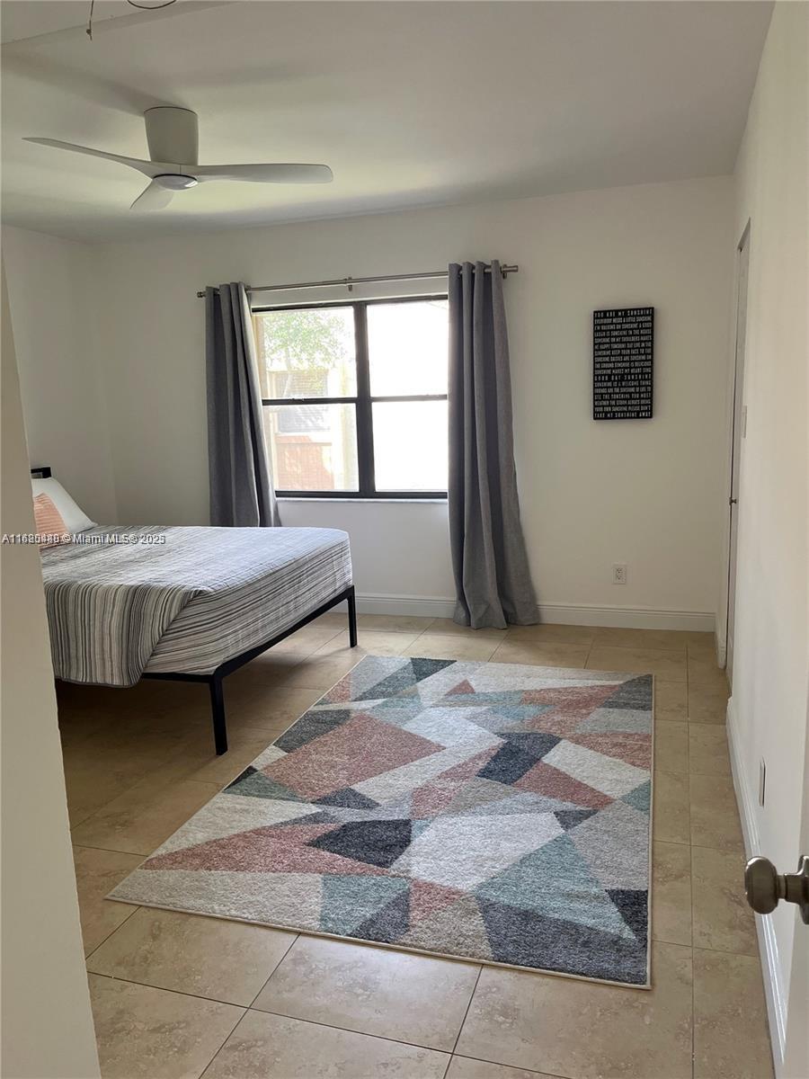 11533 Southwest 109th Road, Unit 21G Miami, FL 33176 - Photo 24 of 39 a bedroom with a bed and a window