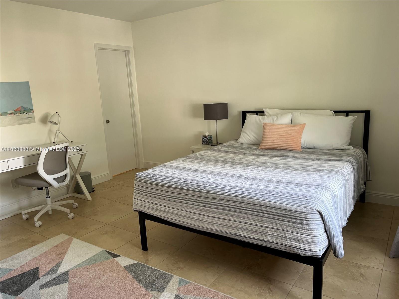 11533 Southwest 109th Road, Unit 21G Miami, FL 33176 - Photo 25 of 39 a bedroom with a bed and a chair