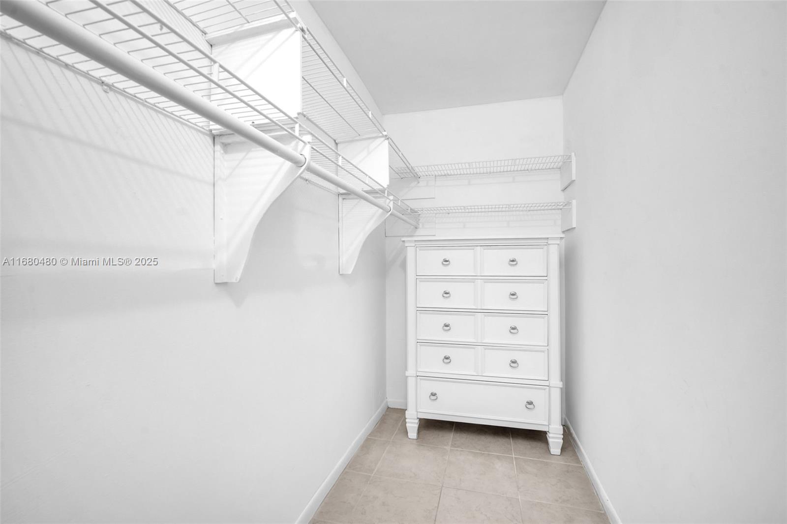 11533 Southwest 109th Road, Unit 21G Miami, FL 33176 - Photo 26 of 39 a view of walk in closet with empty racks