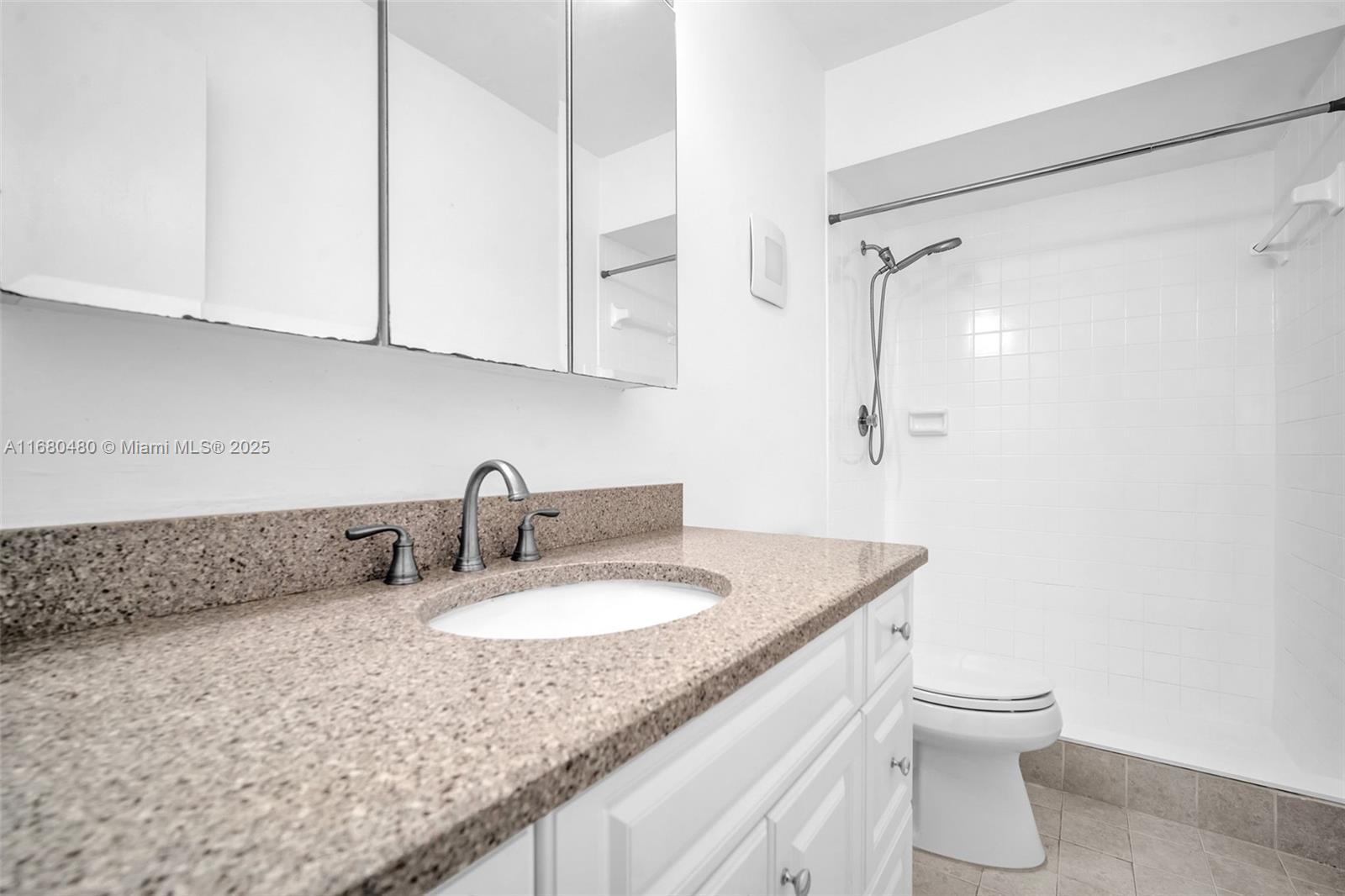 11533 Southwest 109th Road, Unit 21G Miami, FL 33176 - Photo 27 of 39 a bathroom with a granite countertop sink a toilet and a shower