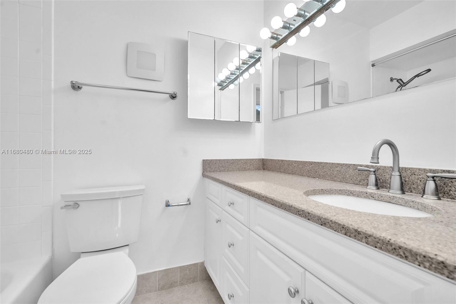 11533 Southwest 109th Road, Unit 21G Miami, FL 33176 - Photo 28 of 39 a bathroom with a granite countertop toilet sink and mirror