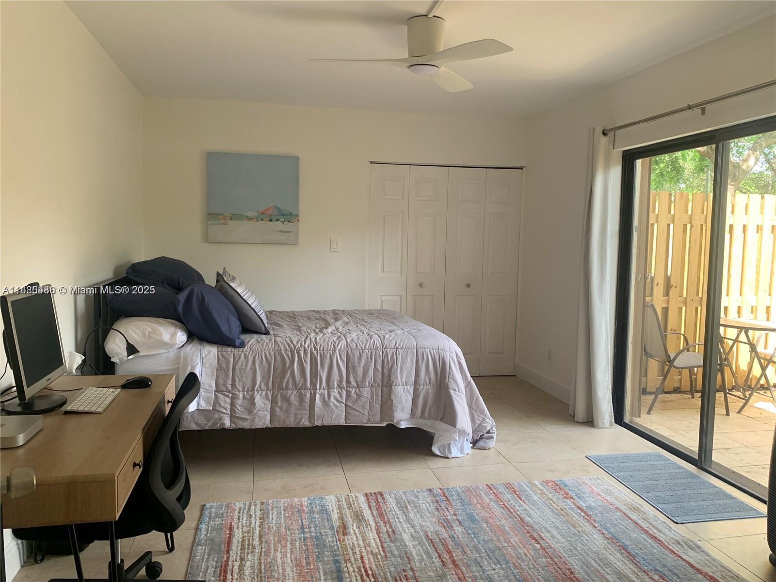 11533 Southwest 109th Road, Unit 21G Miami, FL 33176 - Photo 31 of 39 a bedroom with a bed and wooden floor
