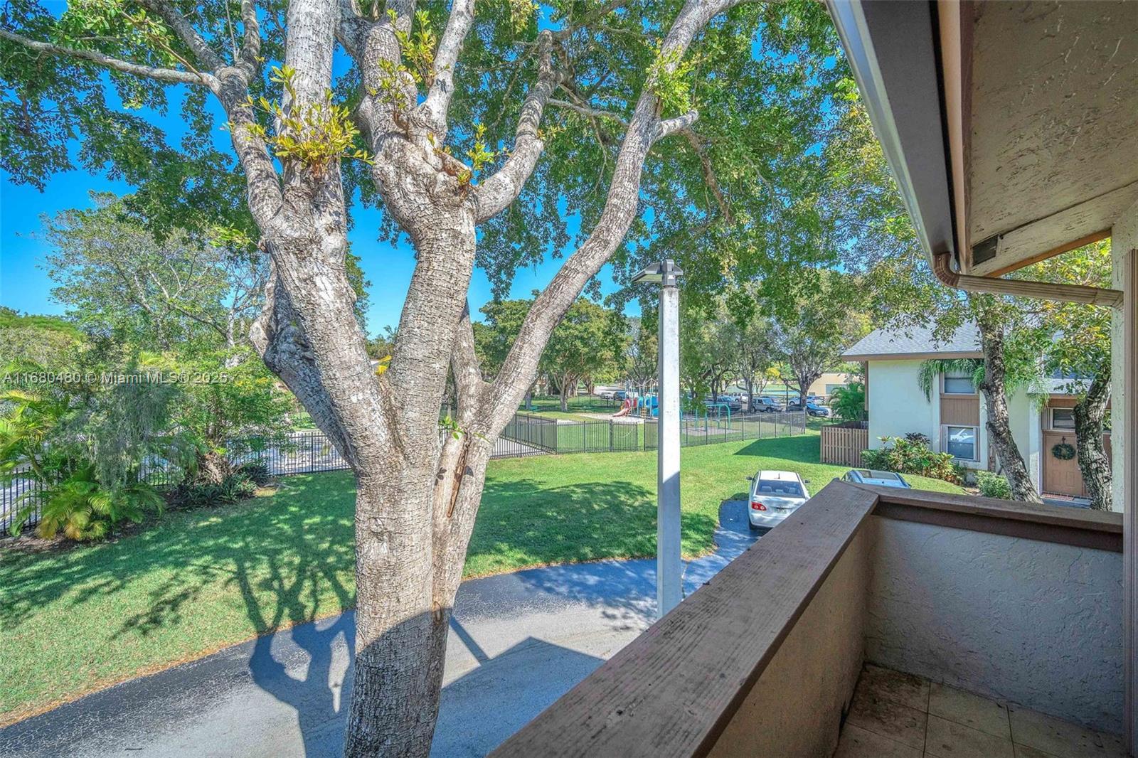 11533 Southwest 109th Road, Unit 21G Miami, FL 33176 - Photo 35 of 39 a view of a sitting area with large trees and a barn in it