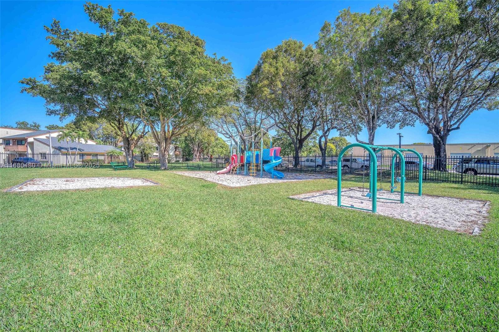11533 Southwest 109th Road, Unit 21G Miami, FL 33176 - Photo 37 of 39 a view of a park with swings and slides