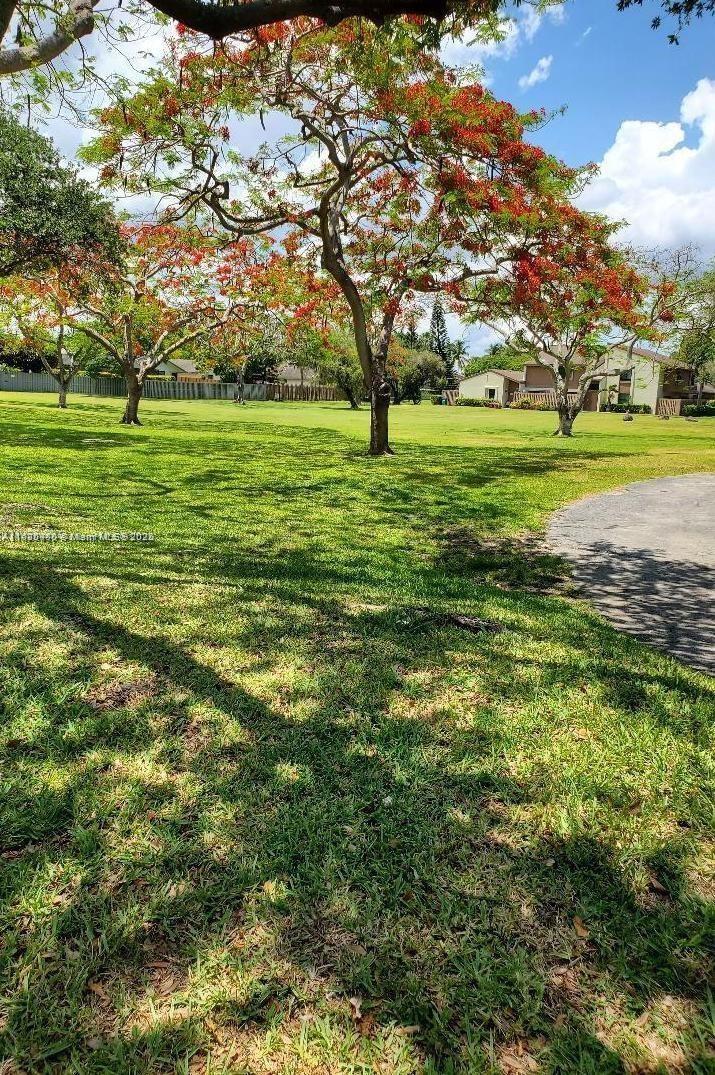 11533 Southwest 109th Road, Unit 21G Miami, FL 33176 - Photo 38 of 39 a big yard with lots of trees