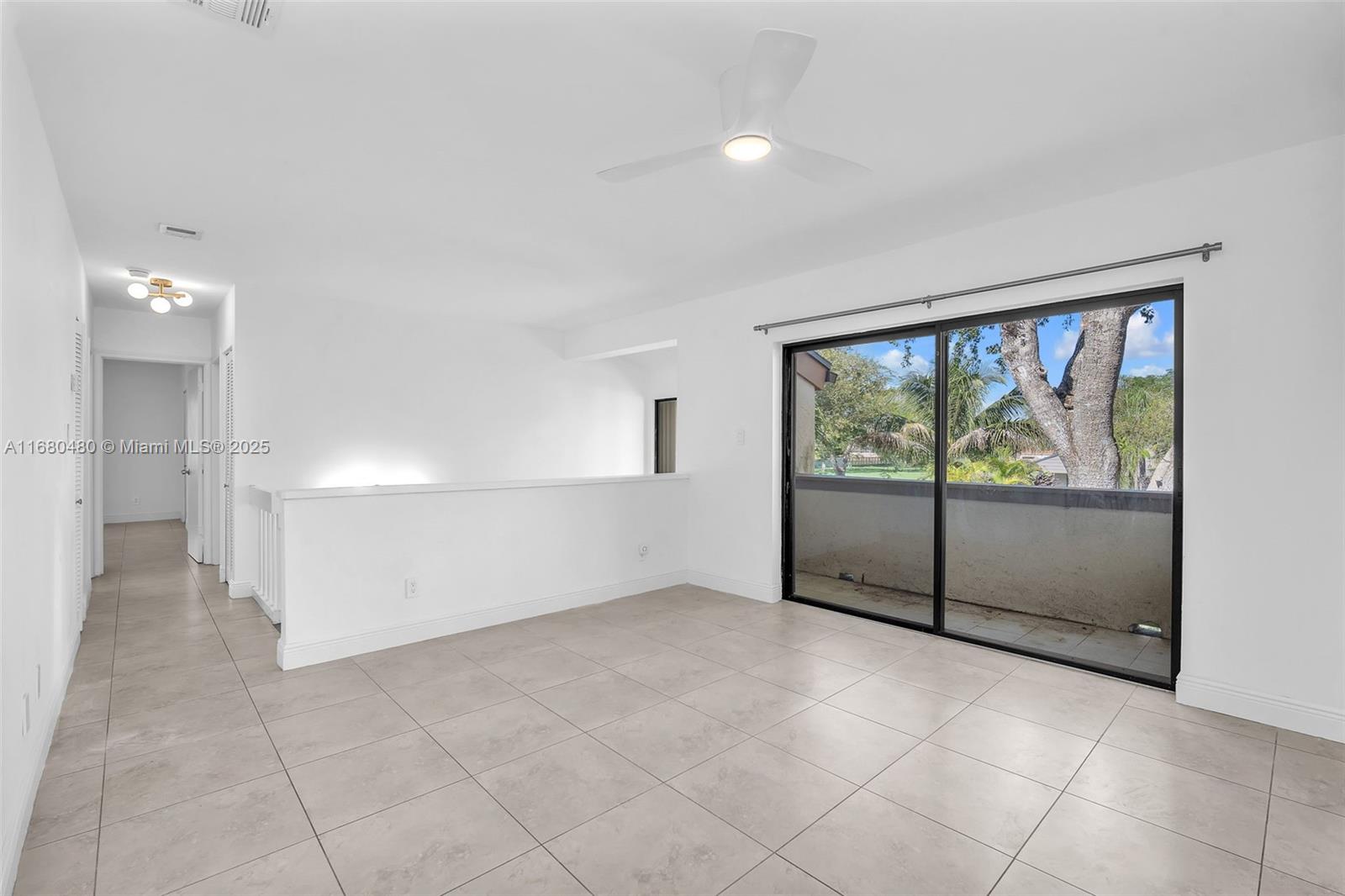 11533 Southwest 109th Road, Unit 21G Miami, FL 33176 - Photo 5 of 39 wooden floor in an empty room with a window