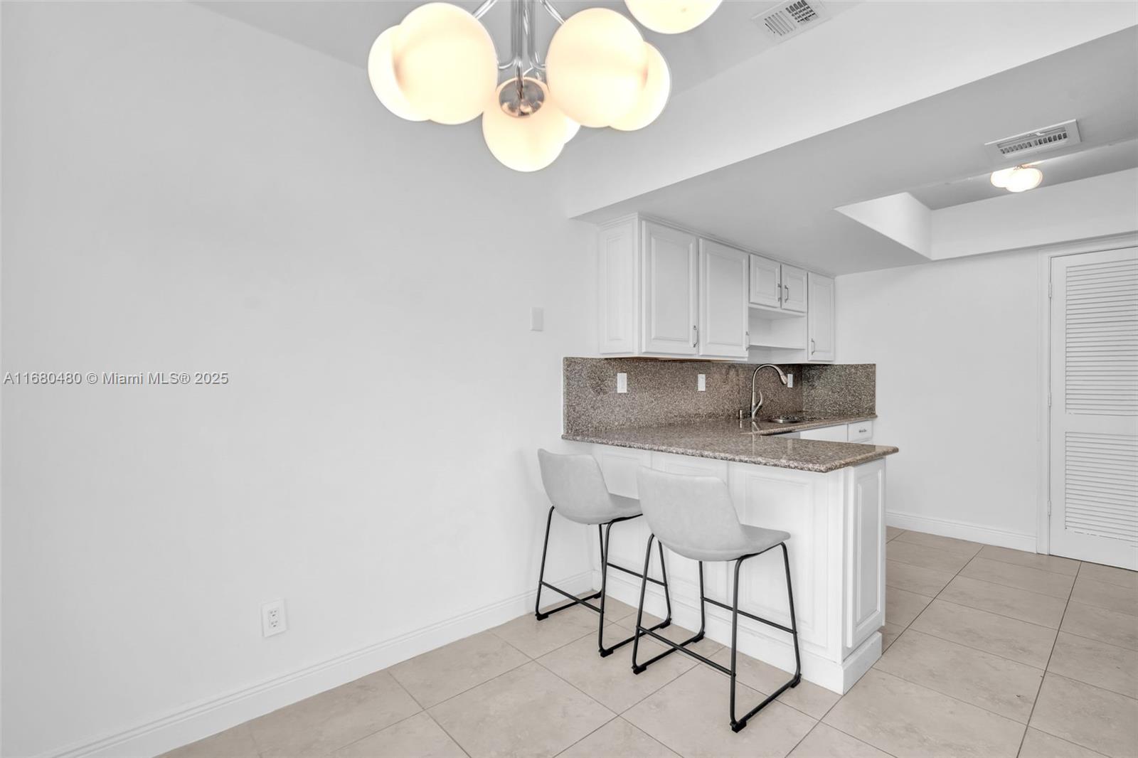 11533 Southwest 109th Road, Unit 21G Miami, FL 33176 - Photo 10 of 39 a kitchen with a sink cabinets and stainless steel appliances